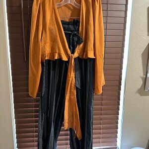 Gold shrug and black stripe pants